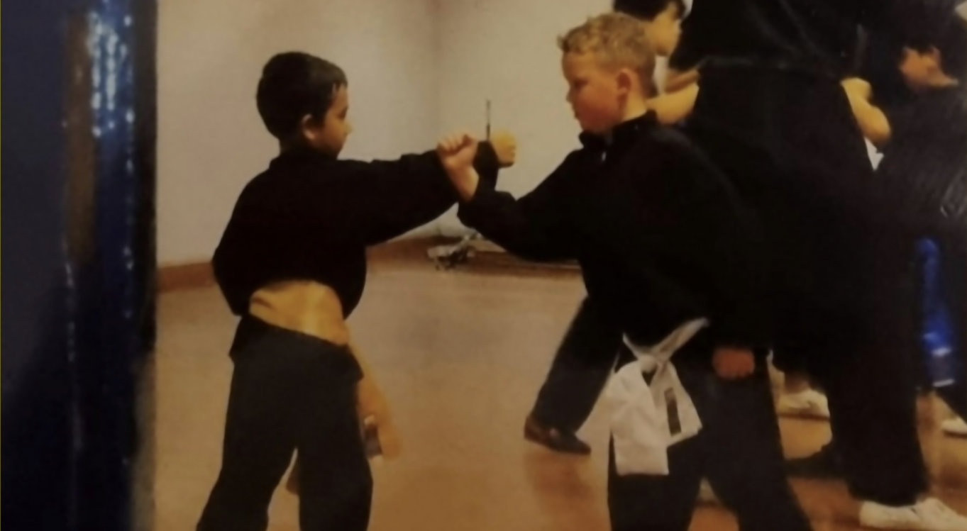 Children learning together in a martial arts class